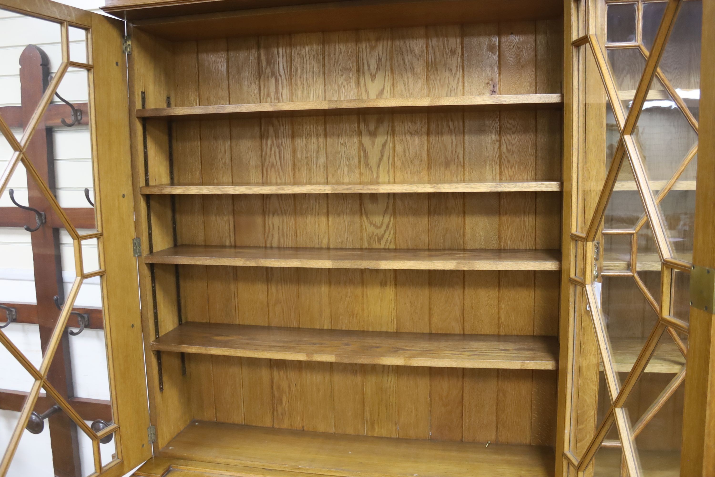 An Edwardian pale oak library bookcase by Robson and Sons of Newcastle, width 190cm, depth 45cm, height 228cm